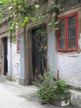 A hutong home growing gourds over its front door.